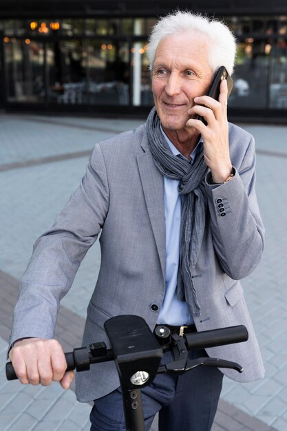 Older man in the city talking on smartphone