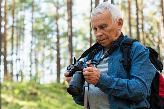 Older man traveling outdoors with camera