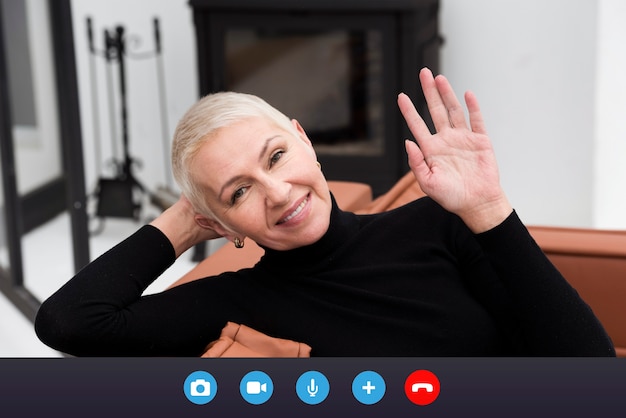 Free photo older person using the video call feature on their device