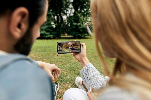 Free photo older person using the video call feature on their device