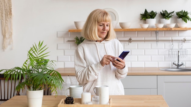 Older woman at home using smartphone