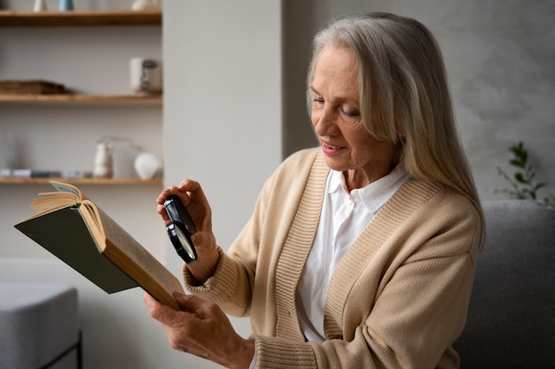 Older woman using a magnifying glass to read