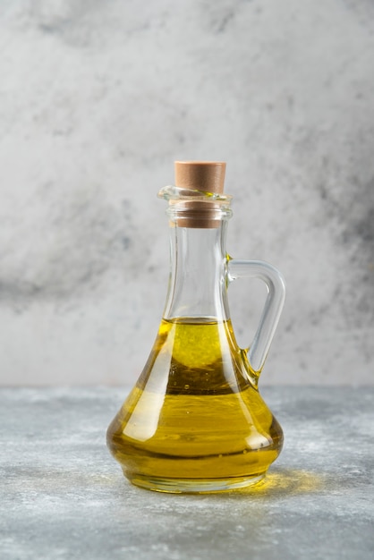 Olive oil bottle on marble table. 