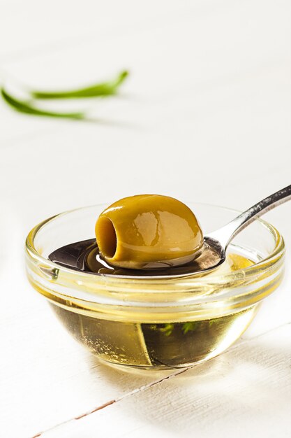 Olive oil and olive branch on the wooden table