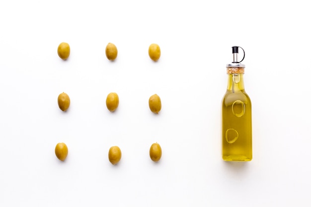 Free photo olive oil with yellow olives arrangement