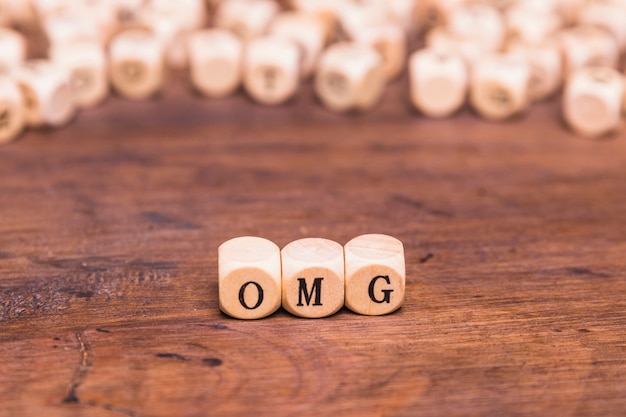 Free photo omg written on a wooden cubes