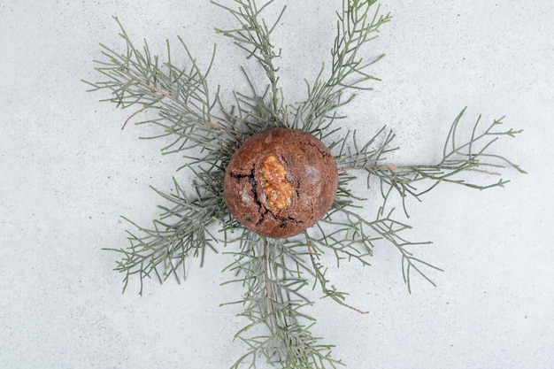 Free Photo one chocolate cookie with walnut on white surface.