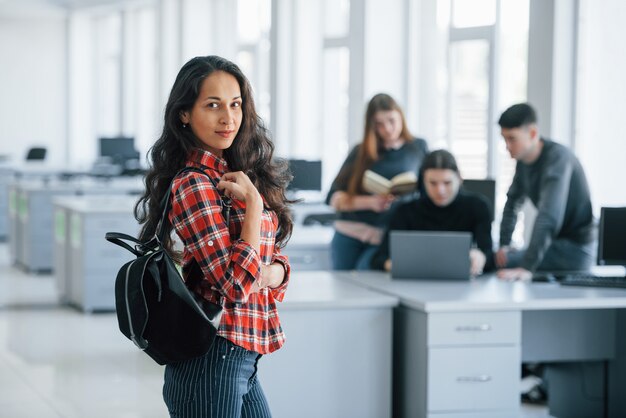 One person focused. Group of young people in casual clothes working in the modern office