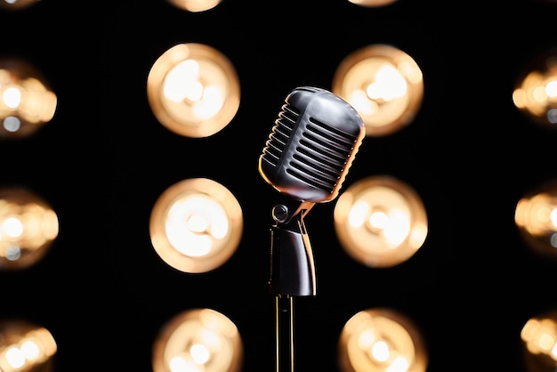 Free Photo one retro microphone on empty stage with bulb lights on backdrop close up view of silver mic on