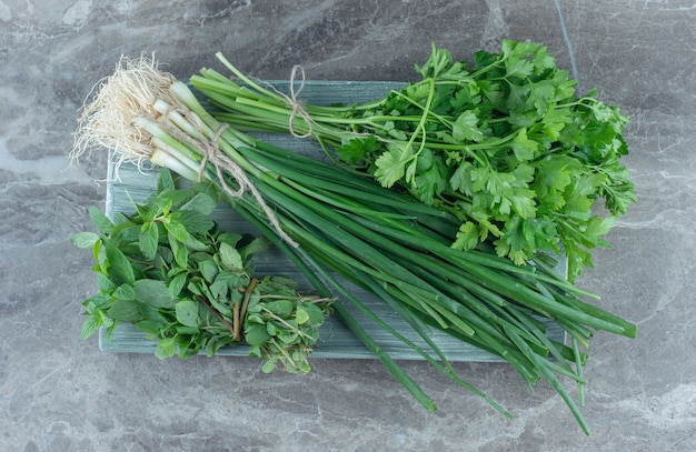 Onion and parsley on the plate , on the marble table. 