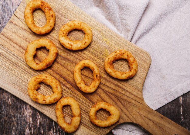 Onion rings on wooden table