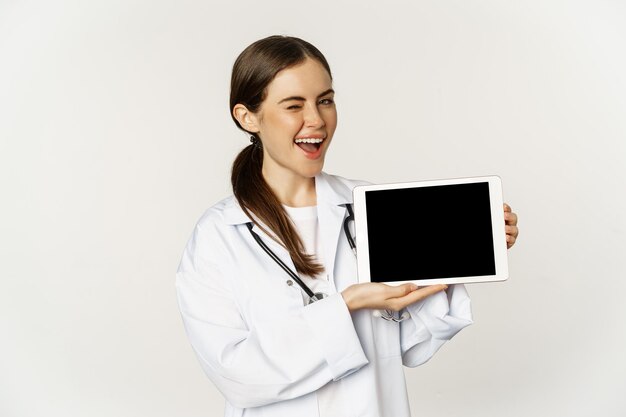 Online medical help remote appointment smiling beautiful woman doctor showing digital tablet screen ...