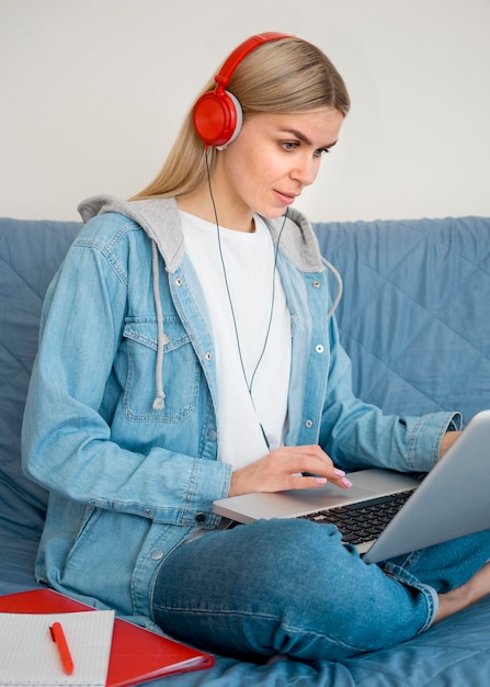 Free photo online remote courses student sitting on sofa