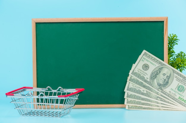 Online shopping , a double cart placed on a green board on a blue  .