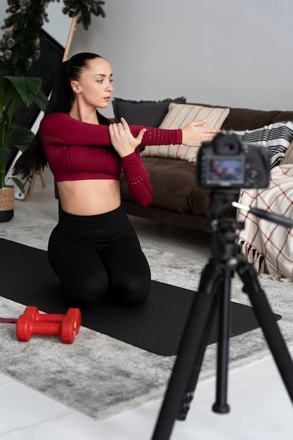 Online sport fitness instructor recording her session