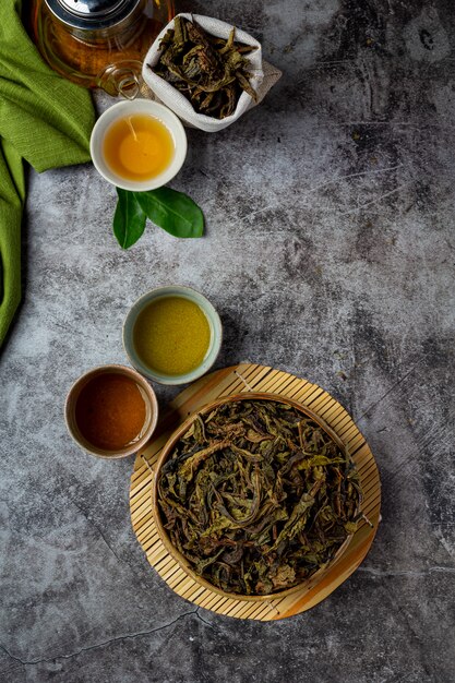 Oolong green tea in a teapot and bowl.