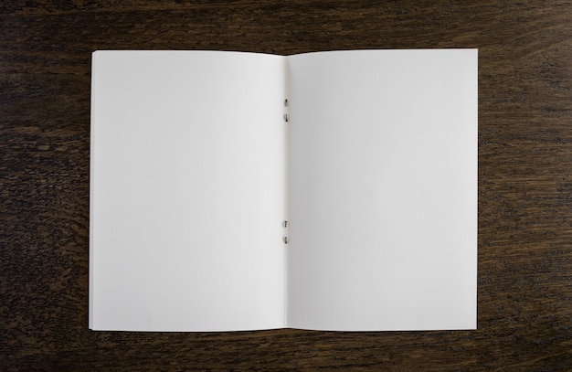 Open blank book on a wooden table