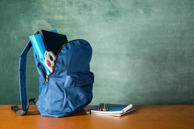 Open knapsack with stationery and watercolors