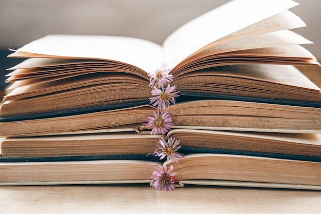 Free photo open old books stacked closeup on blurred background