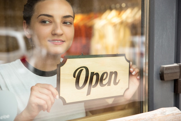 Free photo open sign on the glass of street cafe or restaurant