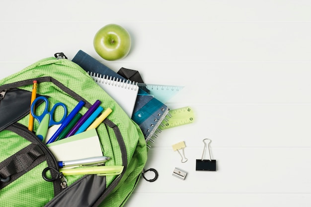 Free Photo opened backpack with school accessories top view