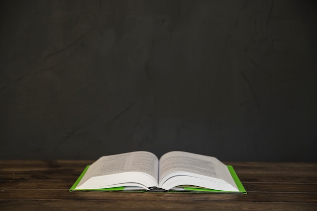 Opened book on wooden table