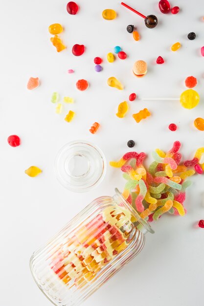 Opened jar near spilled sweets