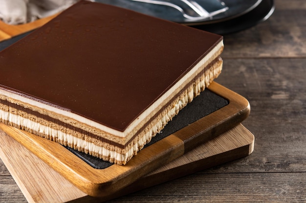 Opera cake dessert slice on wooden table