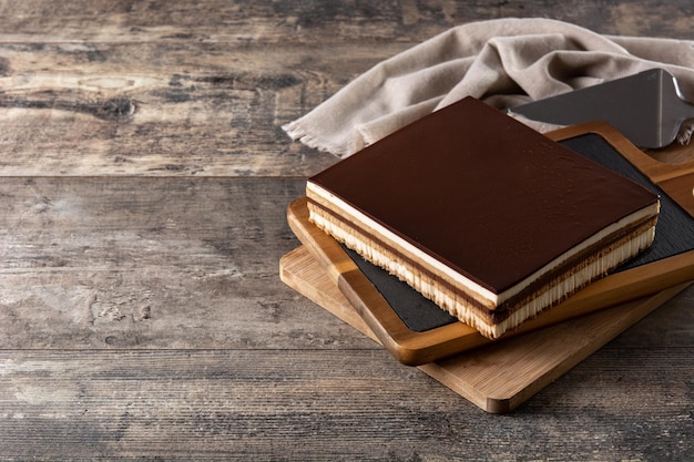 Opera cake dessert on wooden table