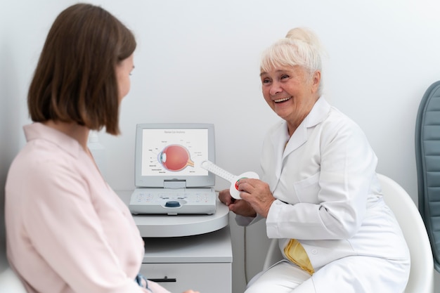 Free Photo ophthalmologist checking a patient in her clinic