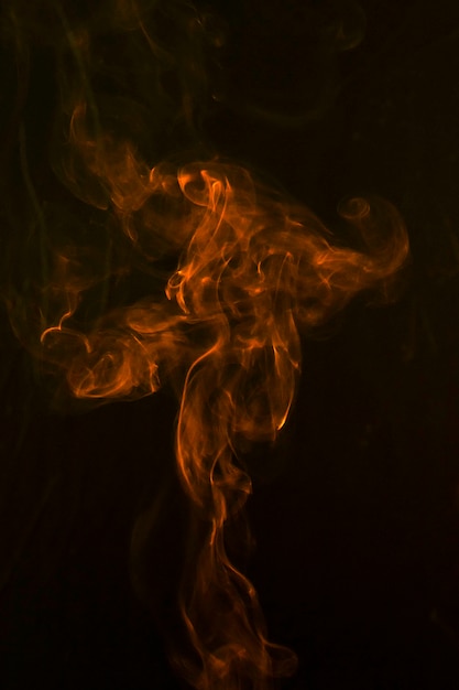 An orange abstract smoke curves and wave on black background