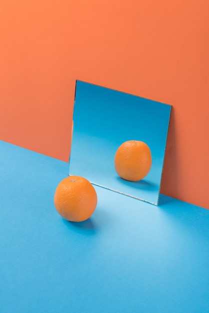 Free Photo orange on blue table isolated on orange