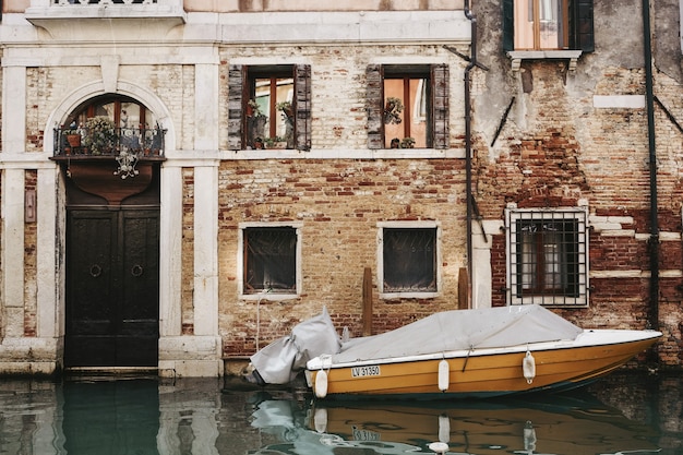 Orange boat in front of building