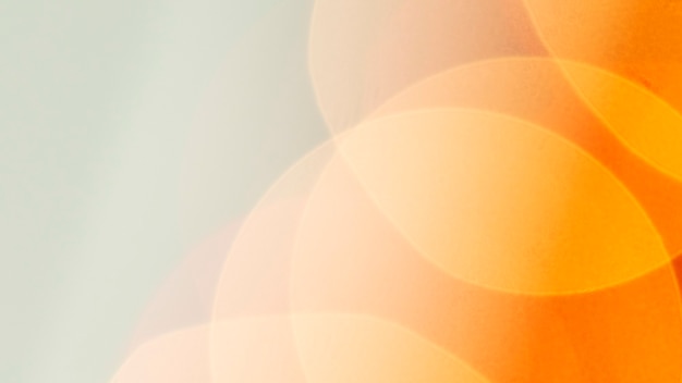 Free photo orange bokeh patterned background wallpaper