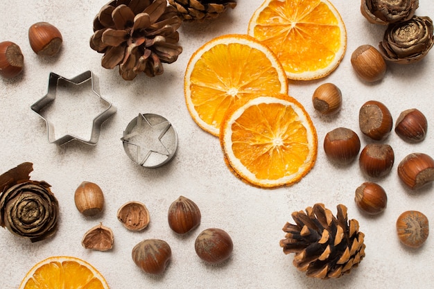 Orange, chestnuts and cooking tools on table