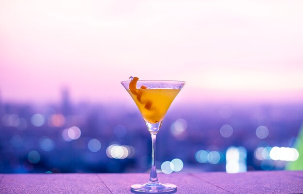 Free Photo orange cocktail at a rooftop