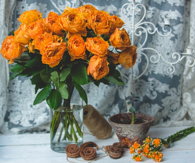 Orange color roses in a jar with water