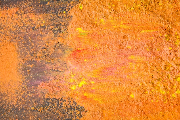 Free Photo orange colourful powder on table