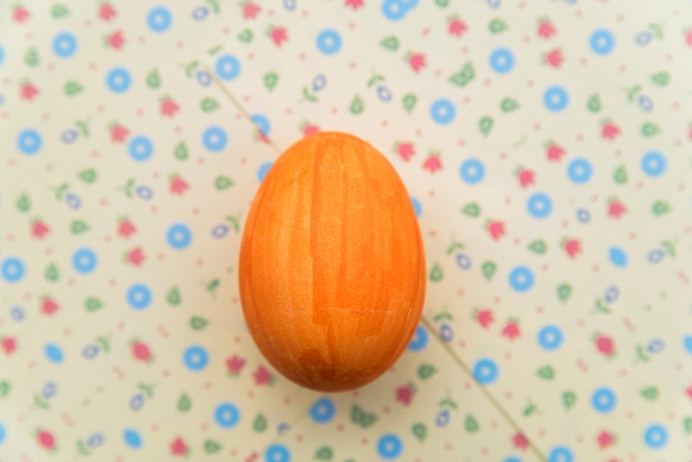 Free photo orange easter egg on board