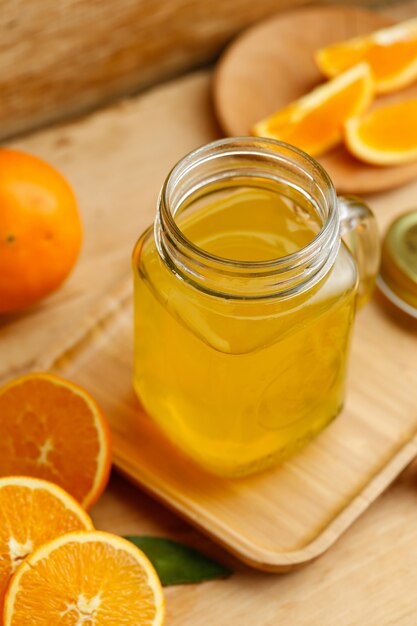 Orange juice and oranges on retro wooden desk