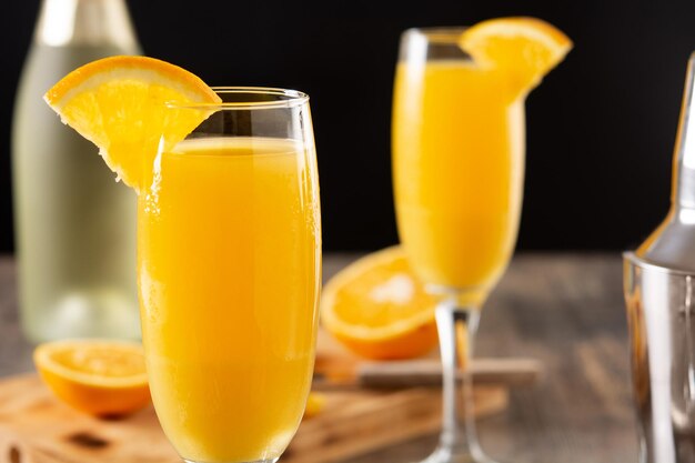 Orange mimosa cocktail on wooden table