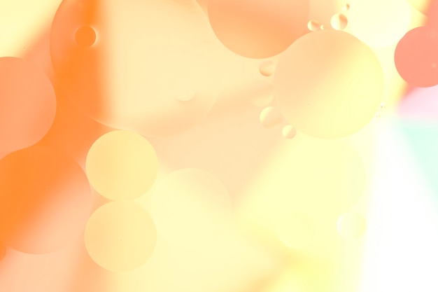 Free Photo orange oil drops on the water surface