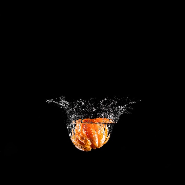 Orange plunging into the water