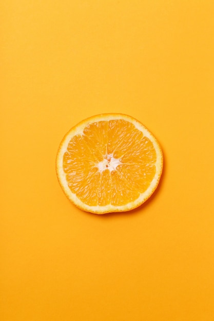 Free Photo orange slice isolated on orange surface