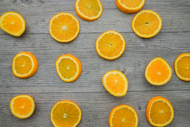 Orange slices on wooden background