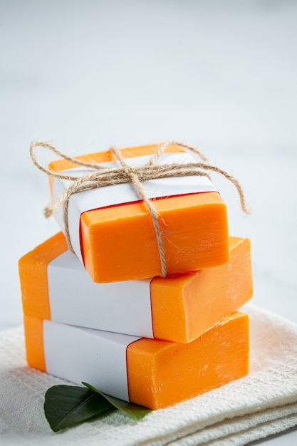 Orange soap with fresh orange on marble background