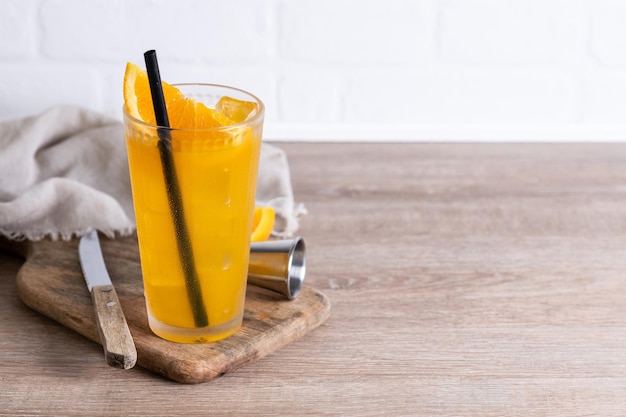 Free photo orange vodka cocktail on wooden table