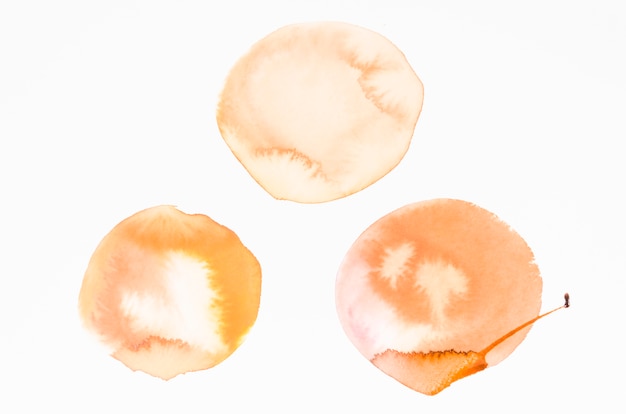 An orange watercolor blots design texture on white background