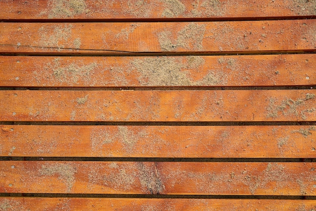 Orange wooden floor with sand