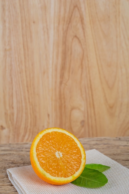 Free Photo orange on the wooden floor.